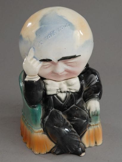 A whimsical tobacco jar depicting a grotesque...