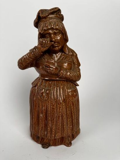 Tobacco jar. Full-length depiction of a sullen...