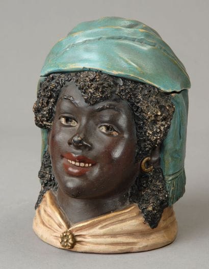 Tobacco jar. The head of a smiling Black...