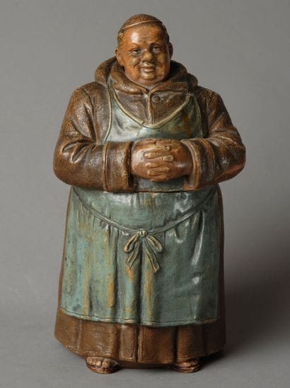 A tall tobacco jar depicting, full-length,...
