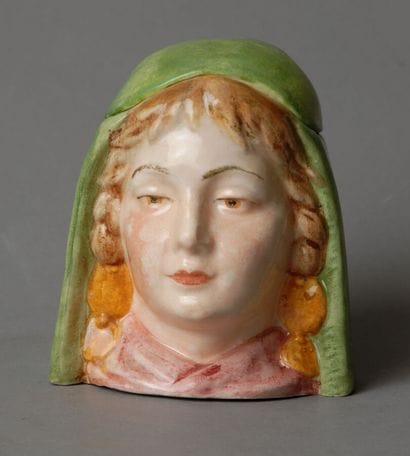 Tobacco jar. A small head of a very young...