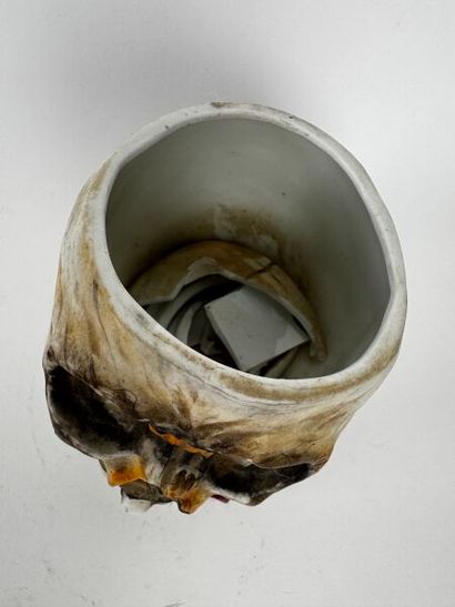 A large tobacco jar made of glossy white...
