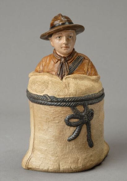 A composite tobacco jar featuring a beige...