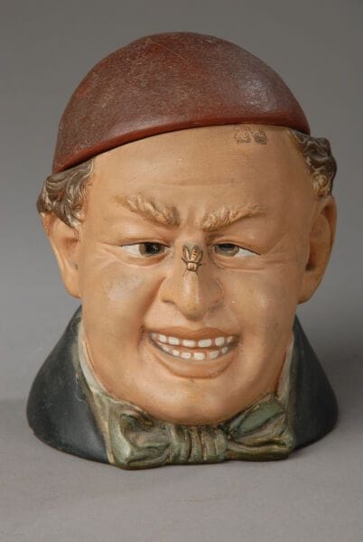 Tobacco jar. A bourgeois man, wearing a house...