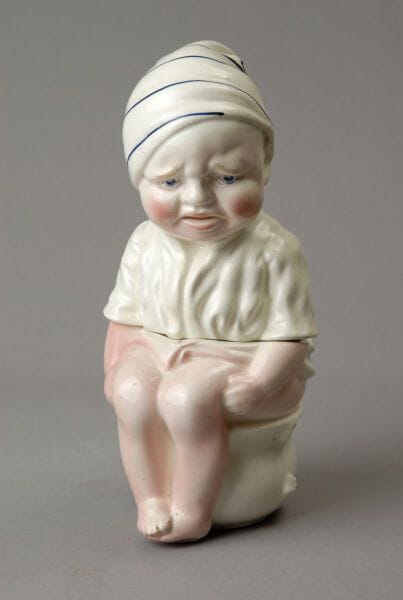 A tall tobacco jar depicting a little boy...
