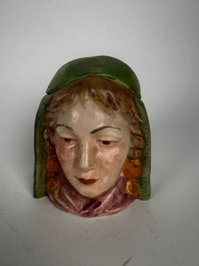 Tobacco jar. A small head of a very young...