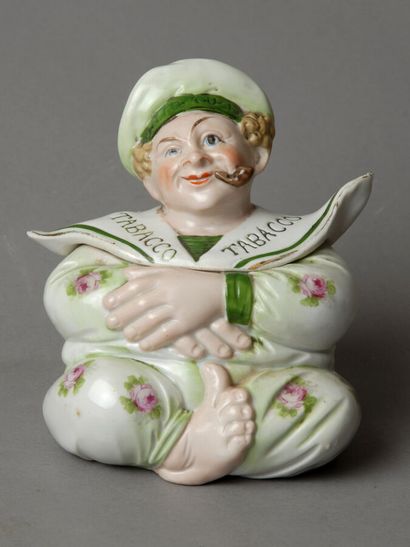 A small pot depicting a grotesque figure...