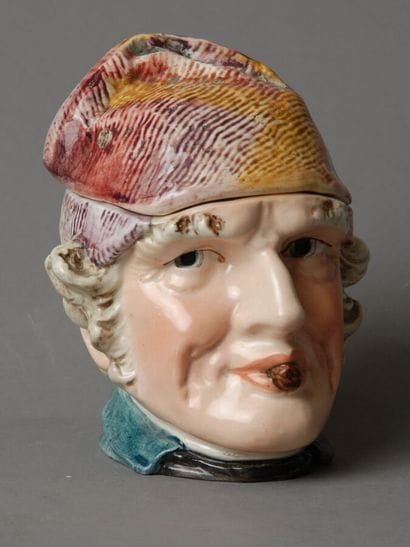 Tobacco jar. The head of an aging man with...