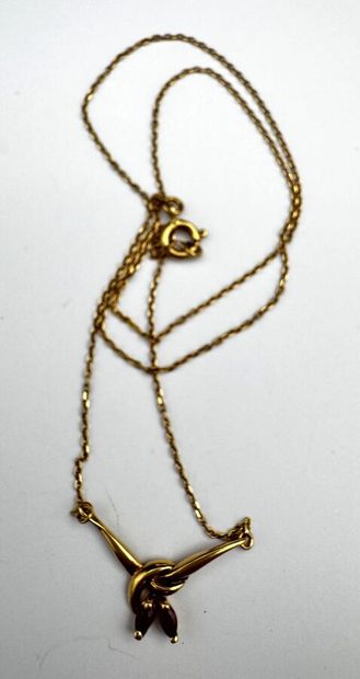 Une chaîne pendentif or retenant deux petits...