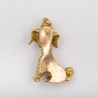 Gold textured poodle pendant with red stones...