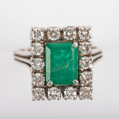 Emerald ring surrounded by brilliant cut...