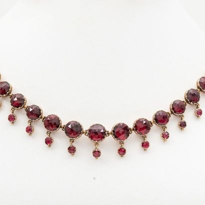 Necklace drapery in light fall, garnets of...