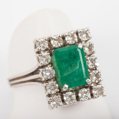 Emerald ring surrounded by brilliant cut...