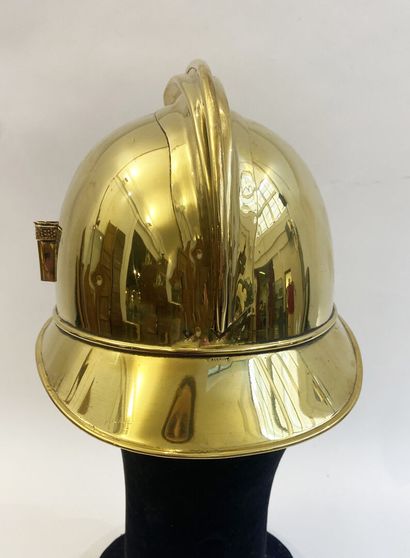 Lot of two brass fireman helmets, one with...