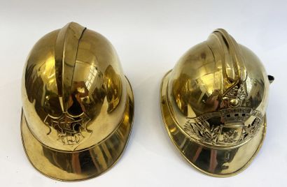 Lot of two brass fireman helmets, one with...