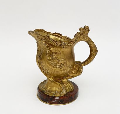 Small ewer in chased and gilded bronze with...