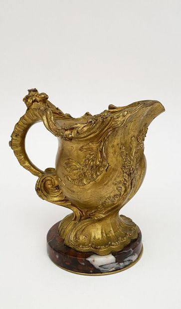 Small ewer in chased and gilded bronze with...