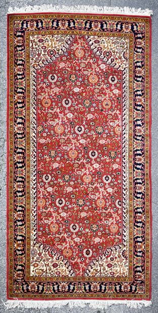 Knotted wool carpet with floral design on...