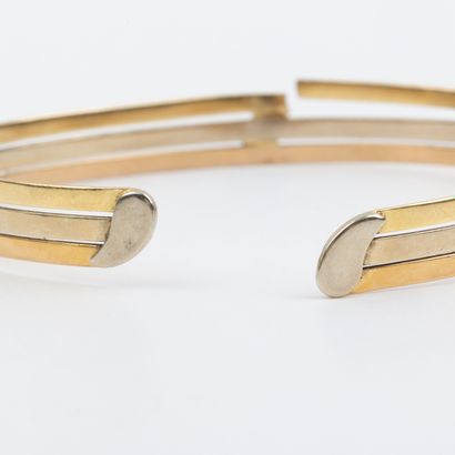 Three 18K gold open half-brace bracelet 
Weight:...