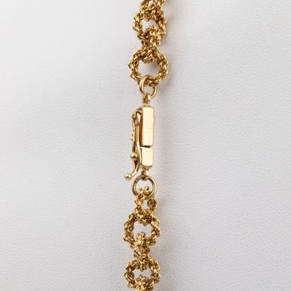 Sautoir in 18K gold, interlaced and textured...