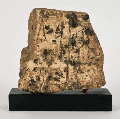 A fragmentary relief decorated on one side...
