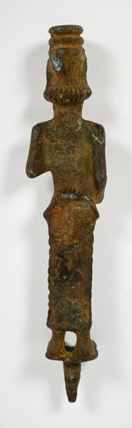 Statuette depicting a dignitary holding a...