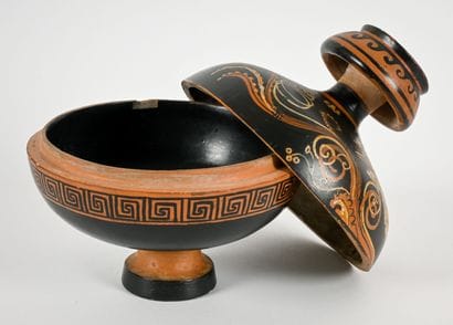 A globular pyxis whose lid is decorated with...