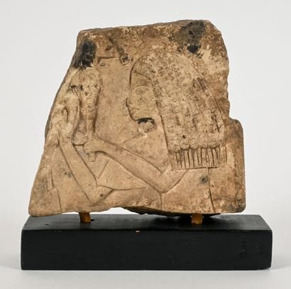 A fragmentary relief decorated on one side...