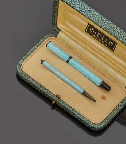 Set comprising a feather pen holder and a...