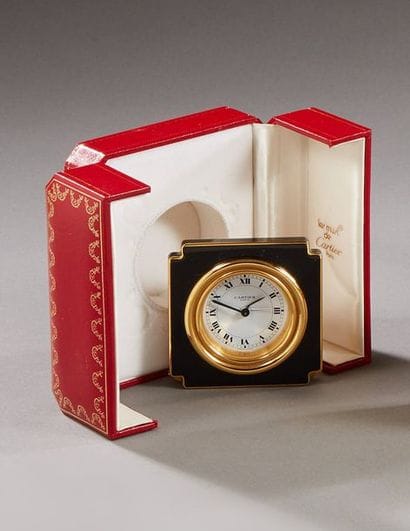 CARTIER

Brass travel clock decorated with...