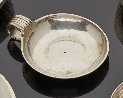 Two small silver wine cups, the roll-up handle...