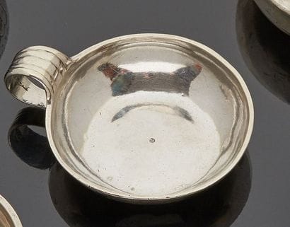 Two small silver wine cups, the roll-up handle...