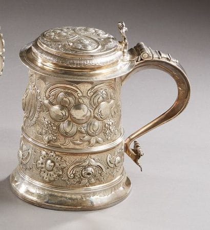 Large silver covered mug with repoussé decoration...