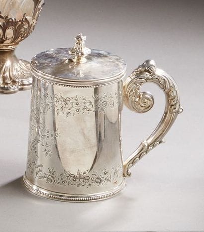Mug covered in silver, the conical body engraved...