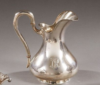 A silver baluster-shaped jug with a flat...
