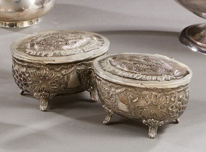 Two silver covered boxes decorated with repelled...