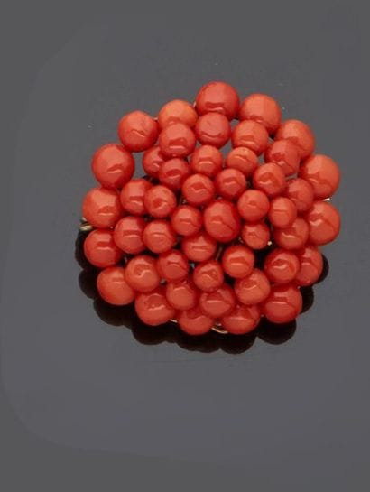 Round brooch decorated with small red coral...