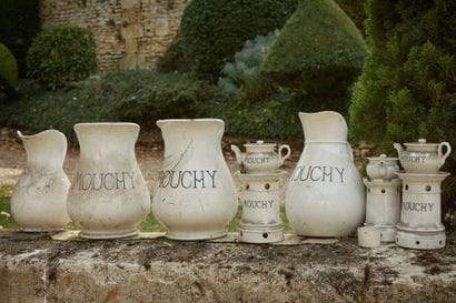 A set of three coffee pots and a white porcelain...