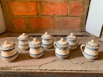Seven small covered earthenware pots with...