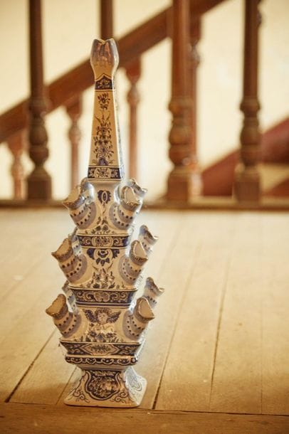 White blue earthenware tulip vase with floral...