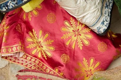 Fuchsia silk with stylized golden palmette...