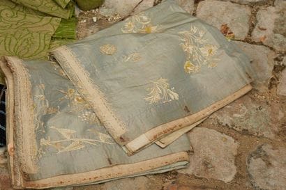 A pair of textiles, blue silks with flower...