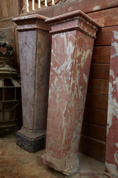 Four columns sheathed in veneer of red veined...
