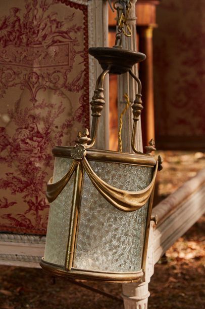 Cylindrical bronze lantern with drapery decoration,...