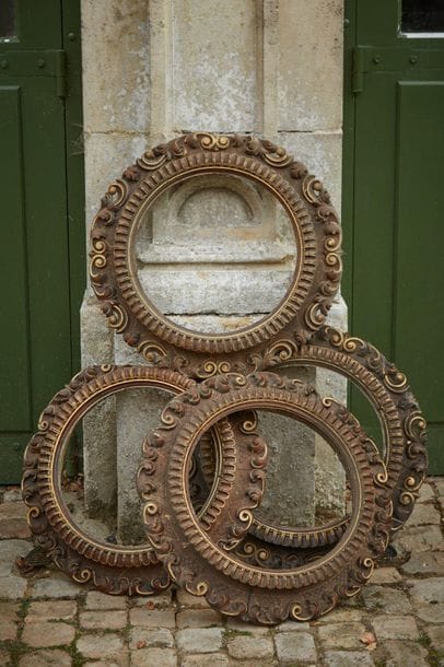 Suite of four round frames in stained and...