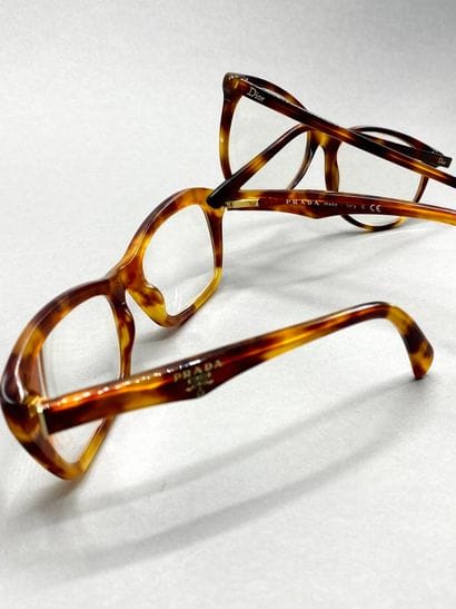 Lot of glasses including : 

PRADA. Eyeglasses,...