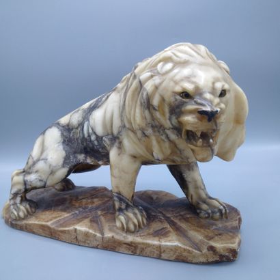 A carved veined alabaster lion, Asian work.

Missing...