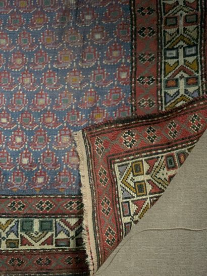 Tapis d'orient à fond bleu et motifs cachemires...