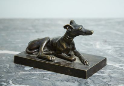 Bronze sculpture of a reclining greyhound,...