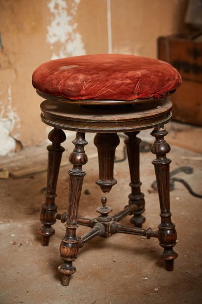 A piano stool on four fluted legs.

19th...